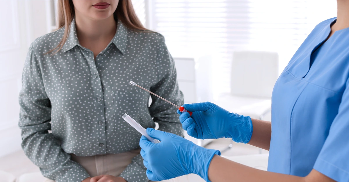Doctor performing STD screening