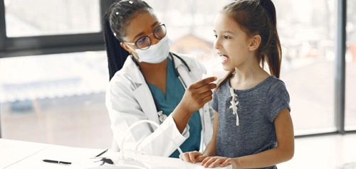 Pediatric doctor consulting a young child