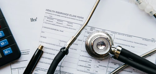 Medical documents and stethoscope on a desk