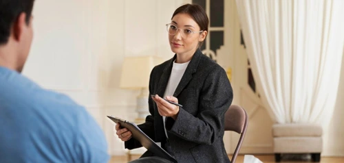 Woman sitting with a mental health professional