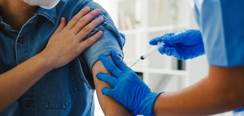 Nurse administering a vaccine to a patient